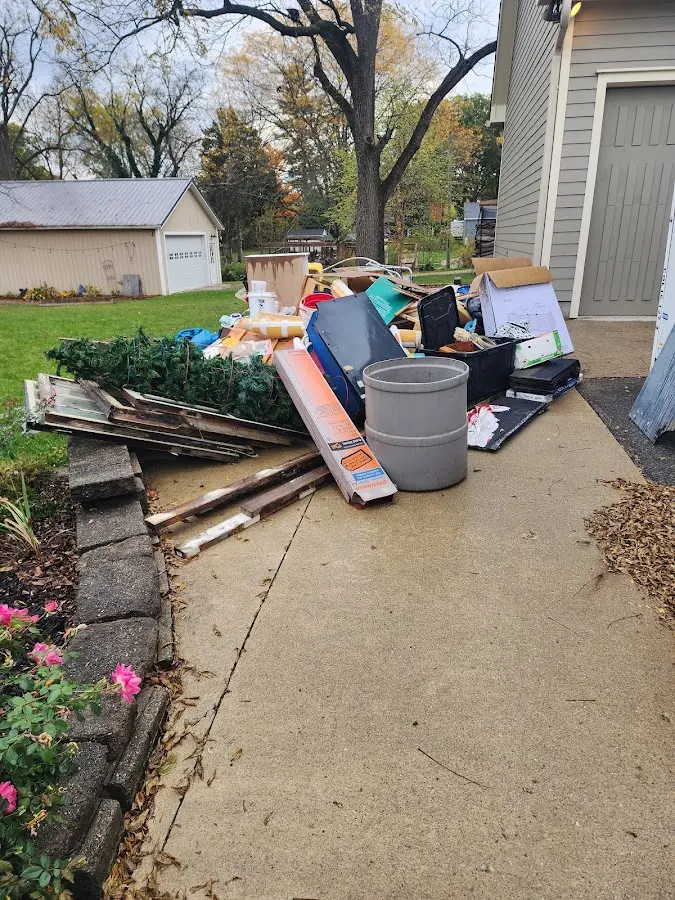Dumpster being loaded with debris for Roofing Dumpster Rental in Southgate